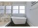 Elegant bathroom with freestanding tub, walk-in shower, and tile flooring at 1727 Cecile Se Ave, Atlanta, GA 30316