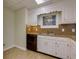 Galley kitchen with white cabinets and tile floors at 4010 Lindley Cir, Powder Springs, GA 30127