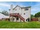 House's back elevation with a deck, lawn, and wooden fence at 980 Charter Club Dr, Lawrenceville, GA 30043