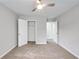 Spacious bedroom with ceiling fan, neutral walls, and plush carpeting at 980 Charter Club Dr, Lawrenceville, GA 30043