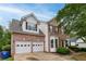 Two-story house with a two-car garage, brick and siding exterior, and landscaping at 980 Charter Club Dr, Lawrenceville, GA 30043