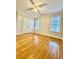 Bright bedroom featuring hardwood floors and double doors at 225 Bayswater Dr, Suwanee, GA 30024