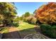 Landscaped backyard with lush lawn and colorful trees at 1344 N Decatur Ne Rd, Atlanta, GA 30306