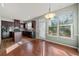 Dark-wood kitchen cabinets, island, and breakfast area at 3330 Sardis Bend Dr, Buford, GA 30519