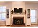 Brick fireplace with a fire burning, flanked by white built-in shelves at 912 Tanners Point Dr, Lawrenceville, GA 30044