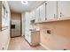 Laundry room with tile floor, sink, and plenty of storage at 1276 Oleander Sw Dr, Lilburn, GA 30047