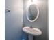 Powder room with pedestal sink and oval mirror at 3461 Parc Sw Dr, Atlanta, GA 30311