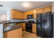 Kitchen with wood cabinets, black appliances, and a dark countertop at 3461 Parc Sw Dr, Atlanta, GA 30311