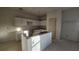 Bright kitchen with white cabinets, an island, and a door at 2116 Boxwood Se Cir, Conyers, GA 30094