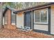 Front entrance of a house with gray door and steps, surrounded by autumn leaves at 2811 Woodfield Dr, Rex, GA 30273