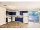 Kitchen features blue cabinets and patio access at 2811 Woodfield Dr, Rex, GA 30273