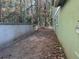 Side yard with a concrete wall and some leaves at 534 Woodcrest Manor Dr, Stone Mountain, GA 30083