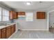 Bright kitchen featuring wood cabinets, double sink, and vinyl flooring at 1167 Atlanta Nw Hwy, Auburn, GA 30011