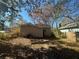 Large backyard with a view of the back of the house and surrounding trees at 1480 Belmont Sw Ave, Atlanta, GA 30310