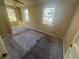 Spacious bedroom with two windows, carpeted floor, and a ceiling fan at 1480 Belmont Sw Ave, Atlanta, GA 30310