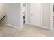 Upstairs hallway with plush carpeting and neutral walls at 1661 Flagstone Ln, Conyers, GA 30012