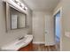 Clean bathroom with vanity, mirror, and wood-look flooring at 2193 Hampton Se Trl, Conyers, GA 30013