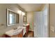 Bathroom with double vanity, wood cabinets, and a large mirror at 2193 Hampton Se Trl, Conyers, GA 30013