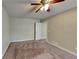 Spacious carpeted bedroom with ceiling fan and door to hallway at 2193 Hampton Se Trl, Conyers, GA 30013