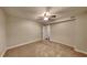 Simple carpeted bedroom with ceiling fan and an attached bathroom at 2193 Hampton Se Trl, Conyers, GA 30013
