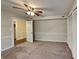 Carpeted bedroom with ceiling fan and ample closet space at 2193 Hampton Se Trl, Conyers, GA 30013
