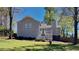 Gray house with deck, green lawn, and mature trees in the backyard at 2193 Hampton Se Trl, Conyers, GA 30013