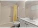Simple bathroom with shower/tub, vanity, and yellow curtain at 2616 Landington Nw Way, Duluth, GA 30096