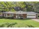 Brick ranch house with attached garage and a spacious lawn at 2616 Landington Nw Way, Duluth, GA 30096