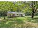 House nestled amongst lush greenery with a large yard at 2616 Landington Nw Way, Duluth, GA 30096