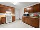 Kitchen boasts wood cabinets, white appliances, and ample counter space at 2616 Landington Nw Way, Duluth, GA 30096