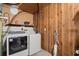 Laundry area with washer, dryer, and wood paneling at 2616 Landington Nw Way, Duluth, GA 30096