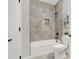 Clean bathroom featuring a shower, toilet, and marble-look tile at 4562 Spring St, Acworth, GA 30101