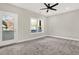 Spacious bedroom with gray carpeting, ceiling fan, and private balcony access at 4562 Spring St, Acworth, GA 30101