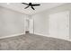 Spacious bedroom with carpet, ceiling fan, and double doors at 4562 Spring St, Acworth, GA 30101