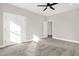 Well-lit bedroom with carpet, ceiling fan and double doors leading to bath at 4562 Spring St, Acworth, GA 30101