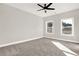 Bright bedroom featuring carpet, ceiling fan and large windows at 4562 Spring St, Acworth, GA 30101