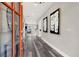 Bright entry hall with gray flooring, an orange door, and modern wall art at 4562 Spring St, Acworth, GA 30101