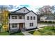 Two-story home with modern farmhouse design, featuring a bright orange door and landscaped lawn at 4562 Spring St, Acworth, GA 30101