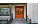 Stylish orange double front door with glass panels, leading to a porch with gray stone tile at 4562 Spring St, Acworth, GA 30101