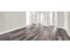 Bright hallway with wide plank gray flooring and multiple doors leading to other rooms at 4562 Spring St, Acworth, GA 30101