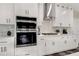 Modern kitchen with white cabinets, stainless steel appliances, and stone backsplash at 4562 Spring St, Acworth, GA 30101