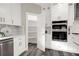 Modern kitchen with white cabinets, stainless steel appliances, and pantry at 4562 Spring St, Acworth, GA 30101