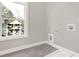 Laundry room with gray tile flooring and a window offering natural light at 4562 Spring St, Acworth, GA 30101