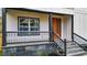 Covered porch with black metal railings and gray stone tile flooring at 4562 Spring St, Acworth, GA 30101