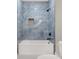 Spa-like shower with blue marble tile and a niche at 4562 Spring St, Acworth, GA 30101