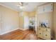 Cozy bedroom with hardwood floors, built-in shelving, and a ceiling fan at 14299 Highway 36, Covington, GA 30014