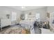 Charming bedroom with white metal bed frame, wicker chairs, and dresser at 14299 Highway 36, Covington, GA 30014