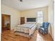 Charming bedroom with hardwood floors, a comfy chair, and plenty of natural light at 14299 Highway 36, Covington, GA 30014