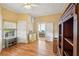 Bedroom with hardwood floors, a dresser, and views of the backyard at 14299 Highway 36, Covington, GA 30014