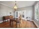 Charming dining room features hardwood floors, antique furniture, and a period-appropriate light fixture at 14299 Highway 36, Covington, GA 30014